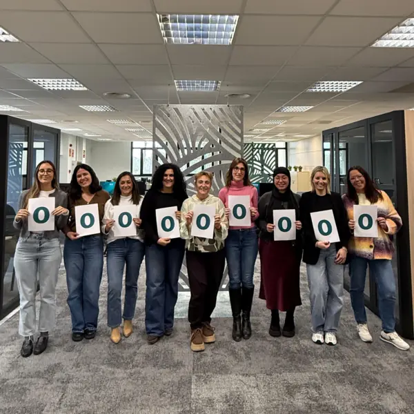 Female colleagues from NETZSCH España hold up signs forming "WOMEN" to celebrate International Women’s Day and diversity.