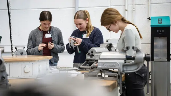 Young women engage in hands-on technical training at NETZSCH's workshop, enhancing skills in MINT professions.