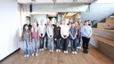 Group of young women and girls standing in modern office space for NETZSCH Girls’ Day event promoting diversity and innovation.