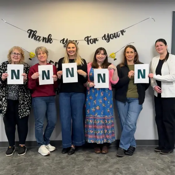 Female colleagues from NETZSCH Premier Technologies hold letters forming the word “WOMEN,” celebrating International Women’s Day.